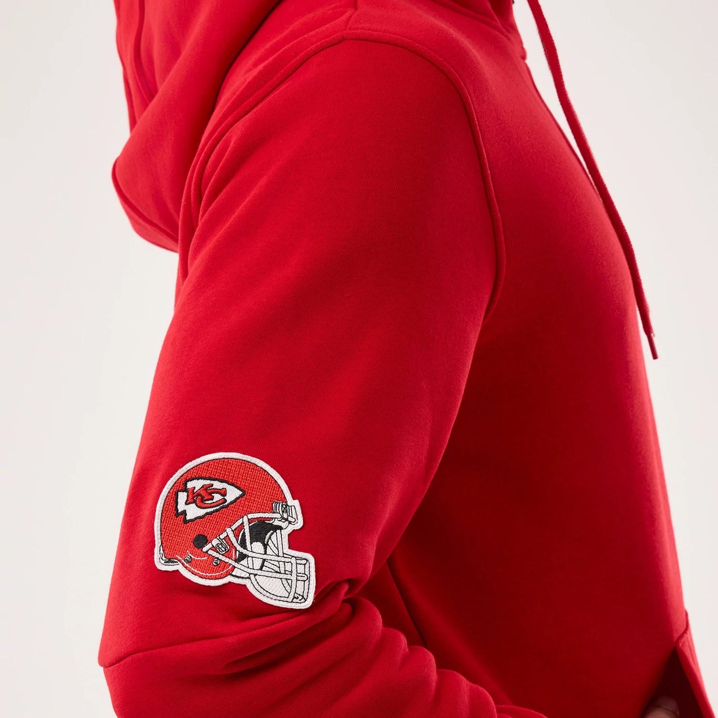 The model is wearing this NFL Sideline 2026 Kansas City Chiefs Pullover Hoodie in red. 4