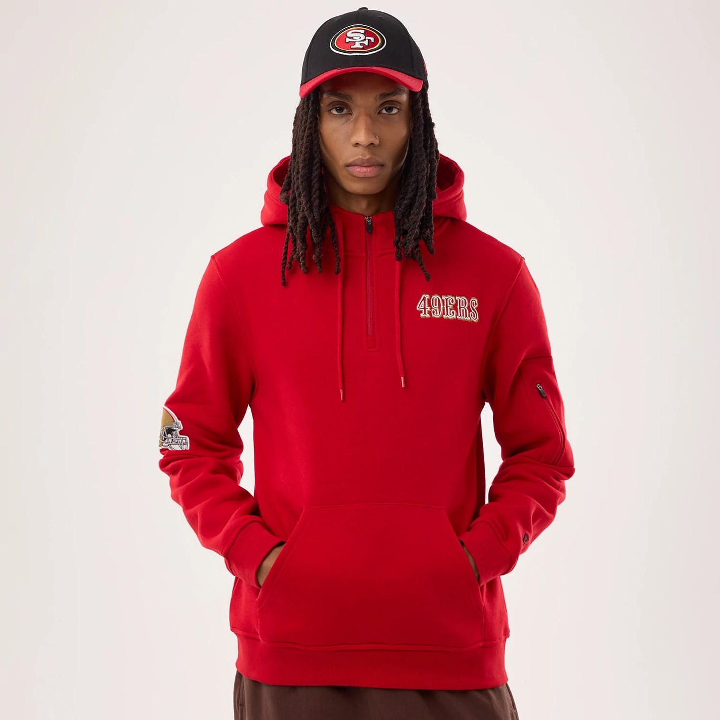The model is wearing this NFL Sideline 2026 San Francisco 49ers Pullover Hoodie in red. 1