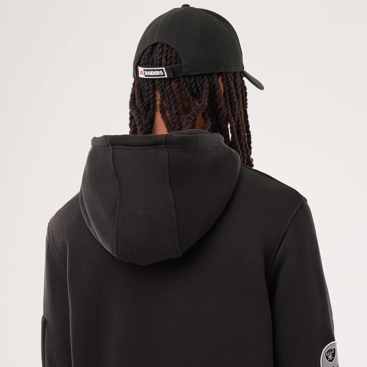 The model is wearing this NFL Sideline 2026 Las Vegas Raiders Pullover Hoodie in black. 5