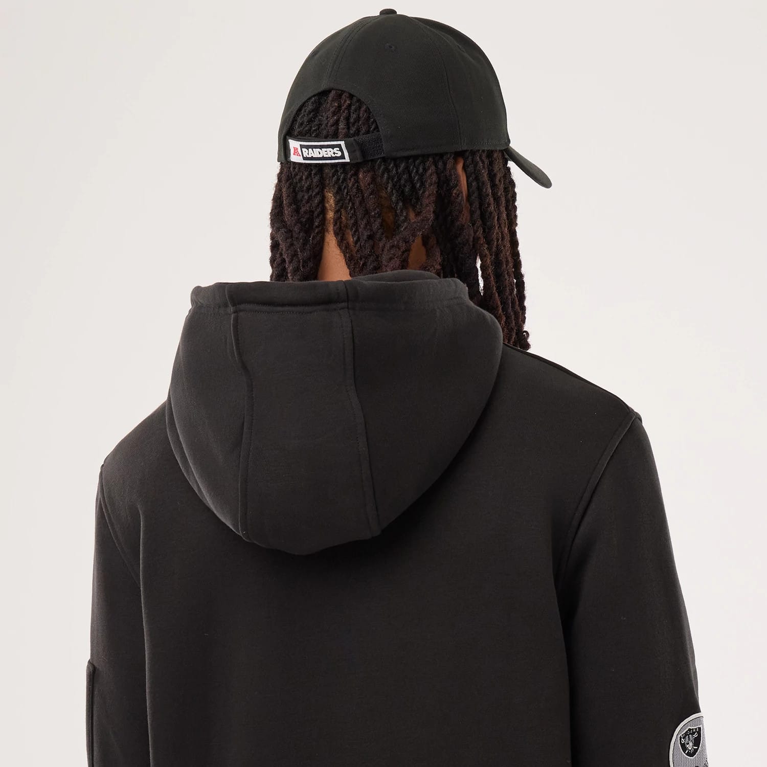 The model is wearing this NFL Sideline 2026 Las Vegas Raiders Pullover Hoodie in black. 5