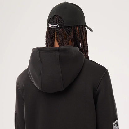 The model is wearing this NFL Sideline 2026 Las Vegas Raiders Pullover Hoodie in black. 5