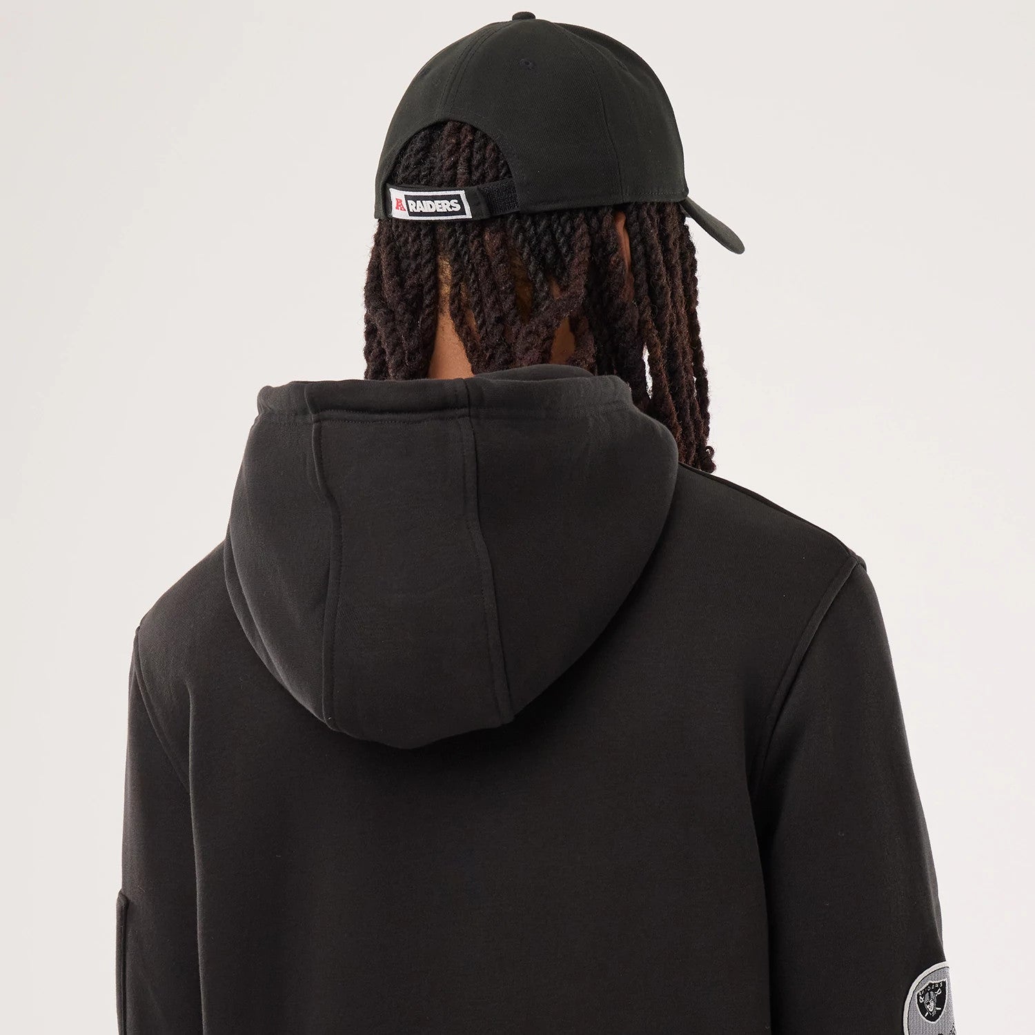 The model is wearing this NFL Sideline 2026 Las Vegas Raiders Pullover Hoodie in black. 5