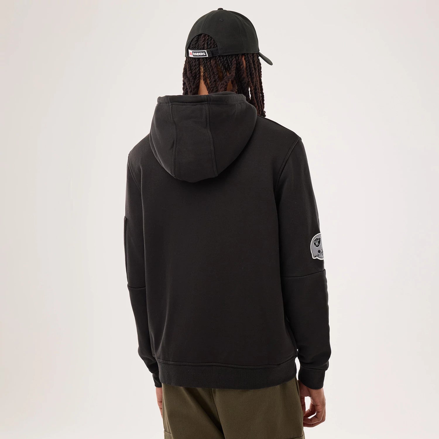 The model is wearing this NFL Sideline 2026 Las Vegas Raiders Pullover Hoodie in black. 2
