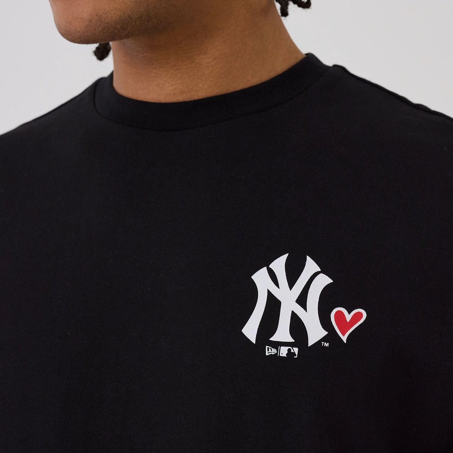 The model is wearing this MLB Heart Graphic New York Yankees T-Shirt in black. 3