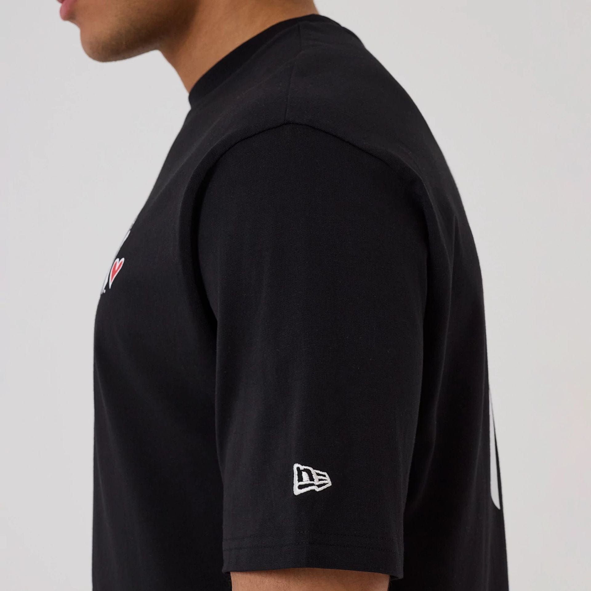 The model is wearing this MLB Heart Graphic New York Yankees T-Shirt in black. 5