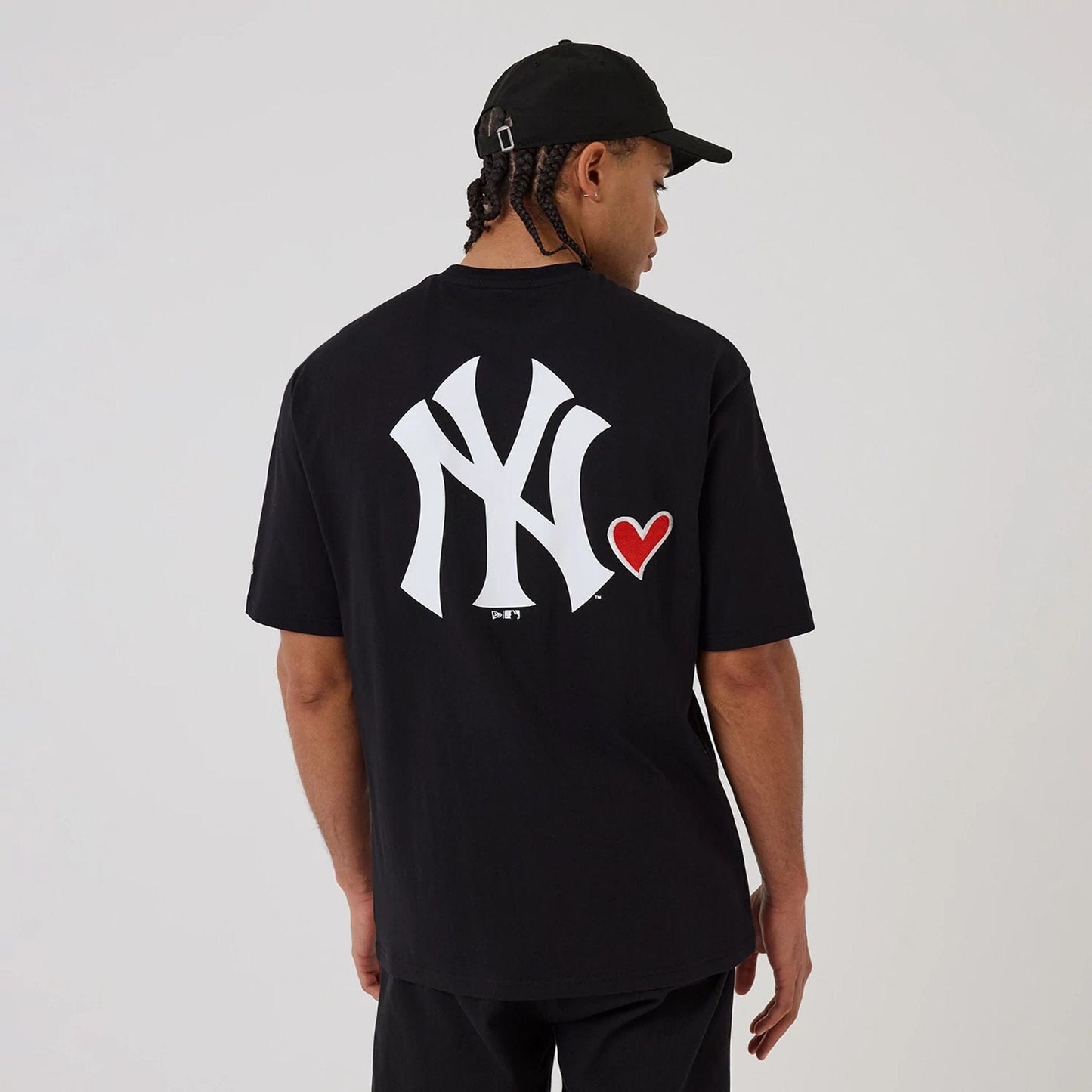 The model is wearing this MLB Heart Graphic New York Yankees T-Shirt in black. 2
