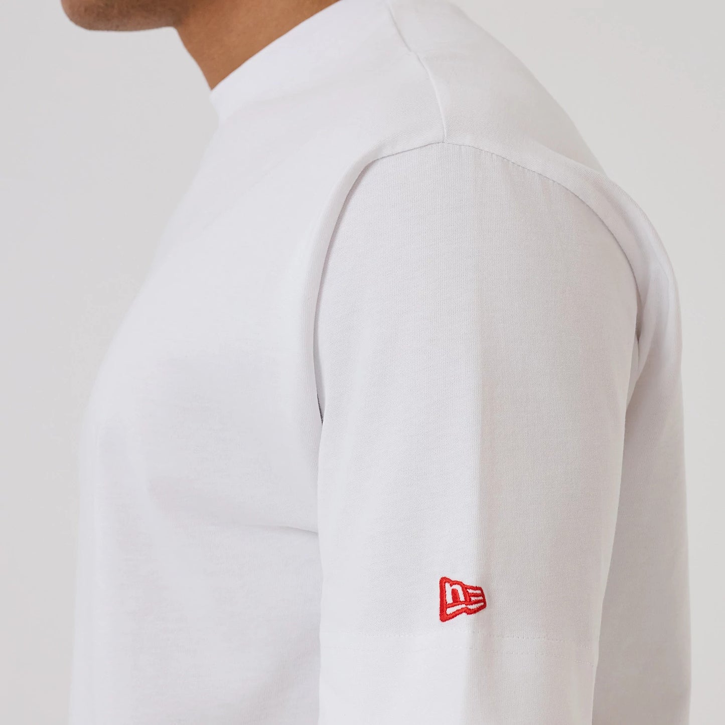 The model is wearing this New Era Love Graphic T-Shirt in white. 5