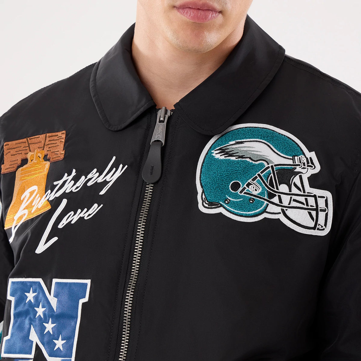 The model is wearing this NFL X Alpha Philadelphia Eagles Jacket in Black. 3