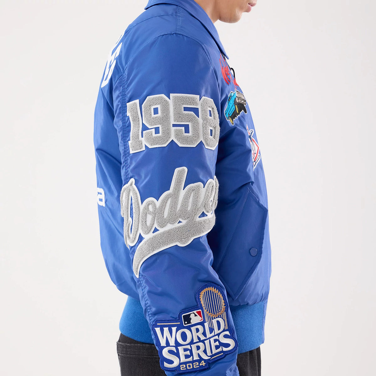 The model is wearing this MLB X Alpha LA Dodgers Jacket in Blue. 3