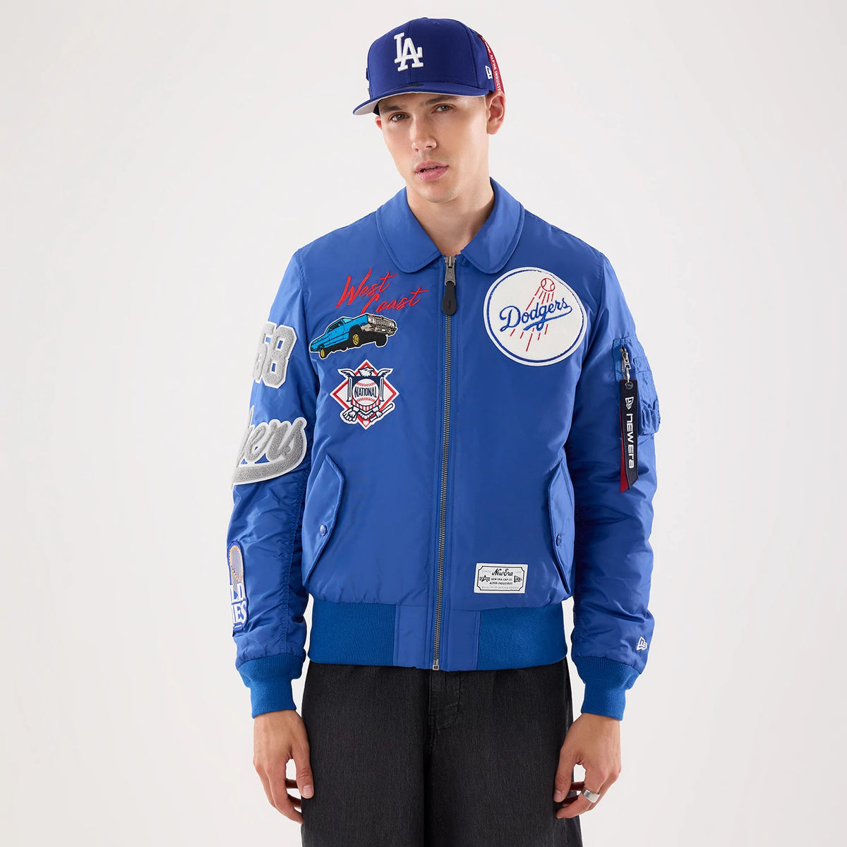The model is wearing this MLB X Alpha LA Dodgers Jacket in Blue. 1