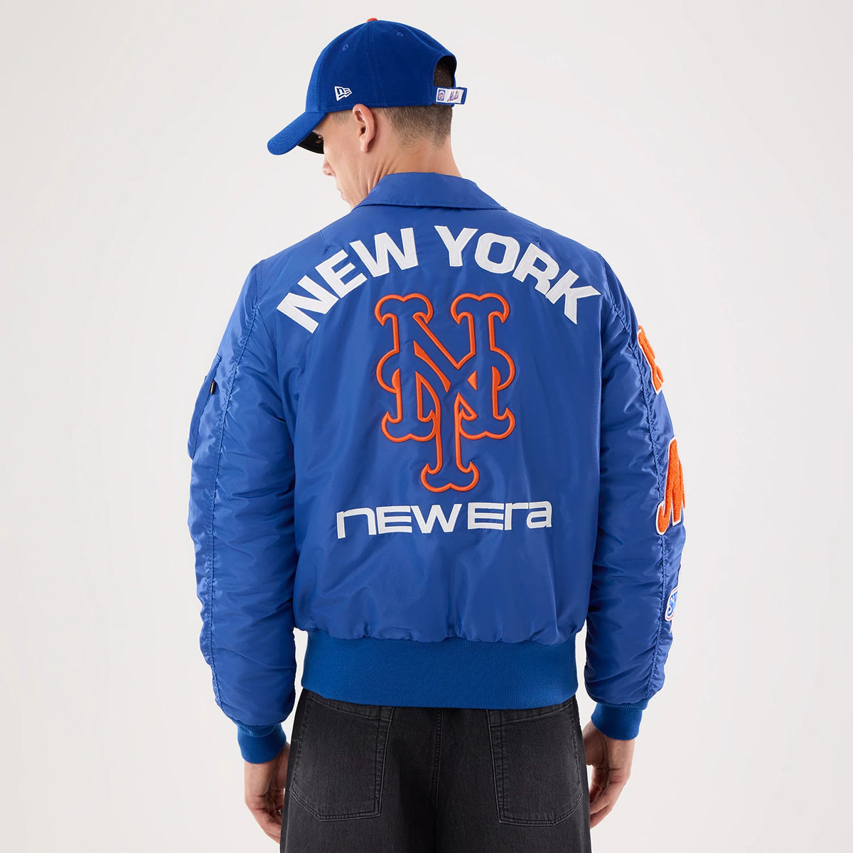 The model is wearing this MLB X Alpha New York Mets Jacket in Blue. 2