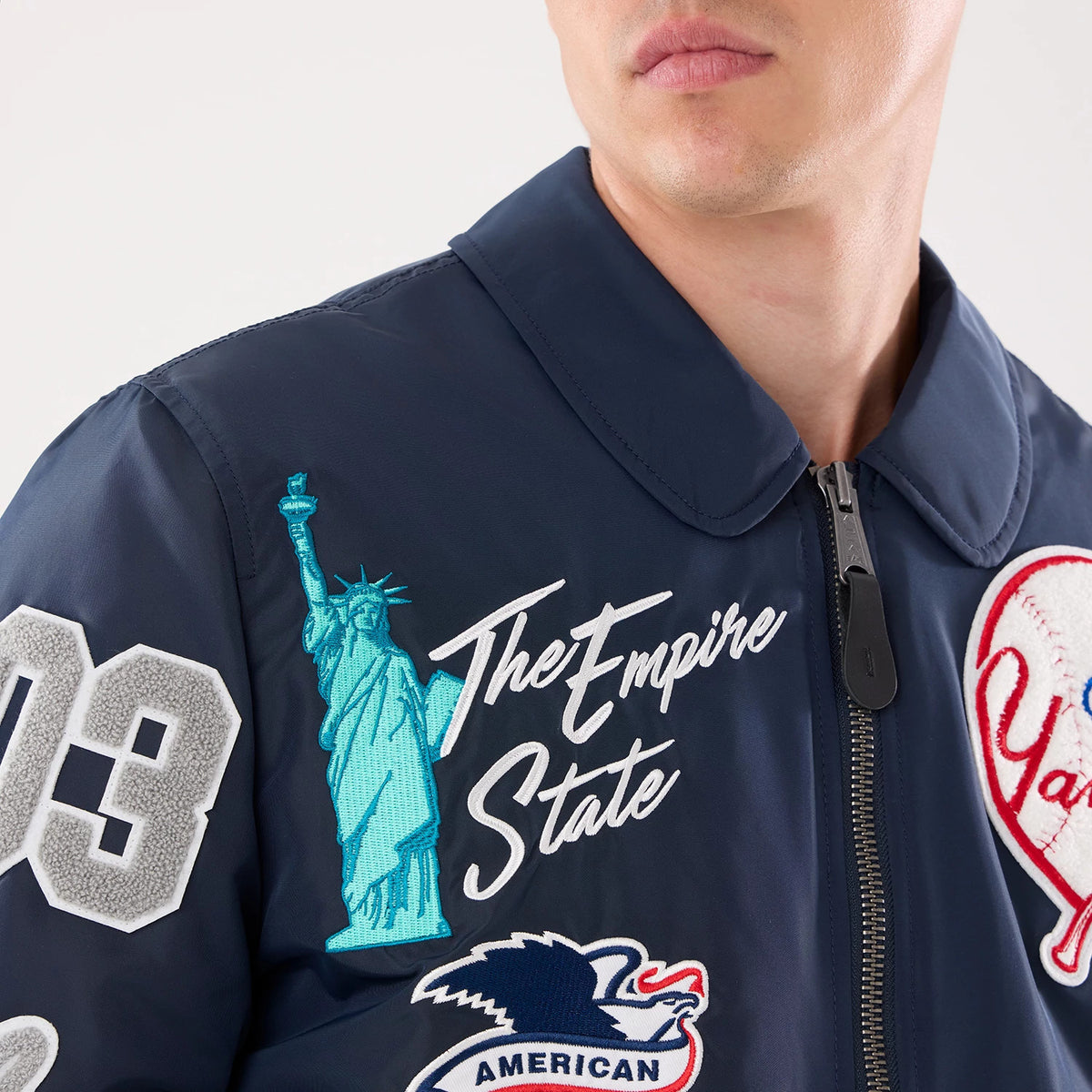 The model is wearing this MLB X Alpha New York Yankees Jacket in navy. 3