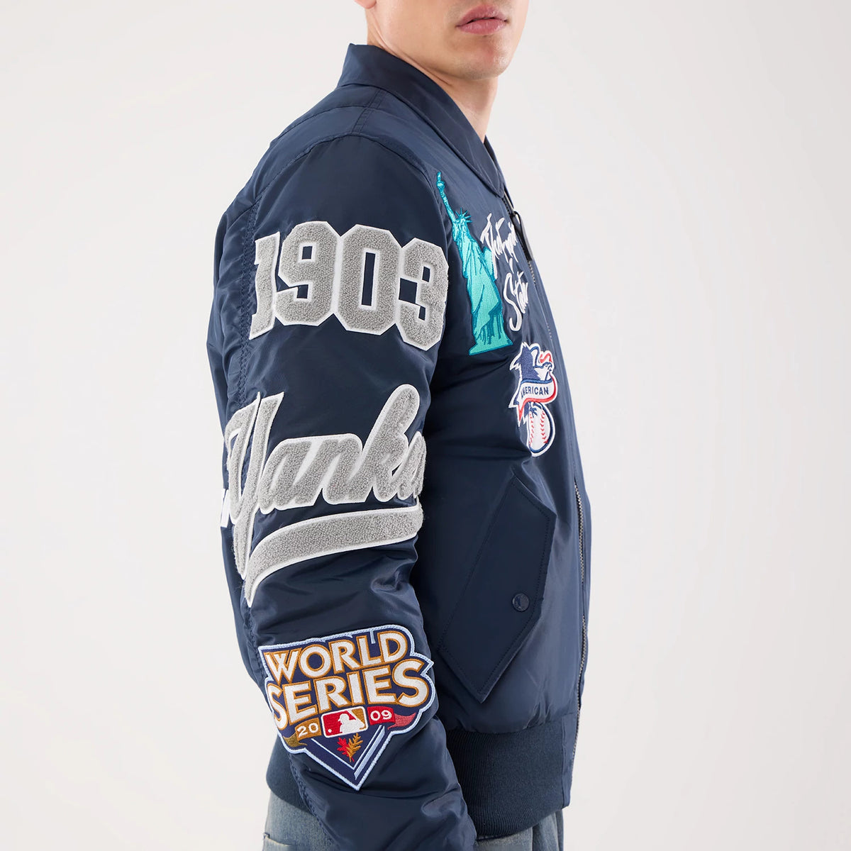 The model is wearing this MLB X Alpha New York Yankees Jacket in navy. 5