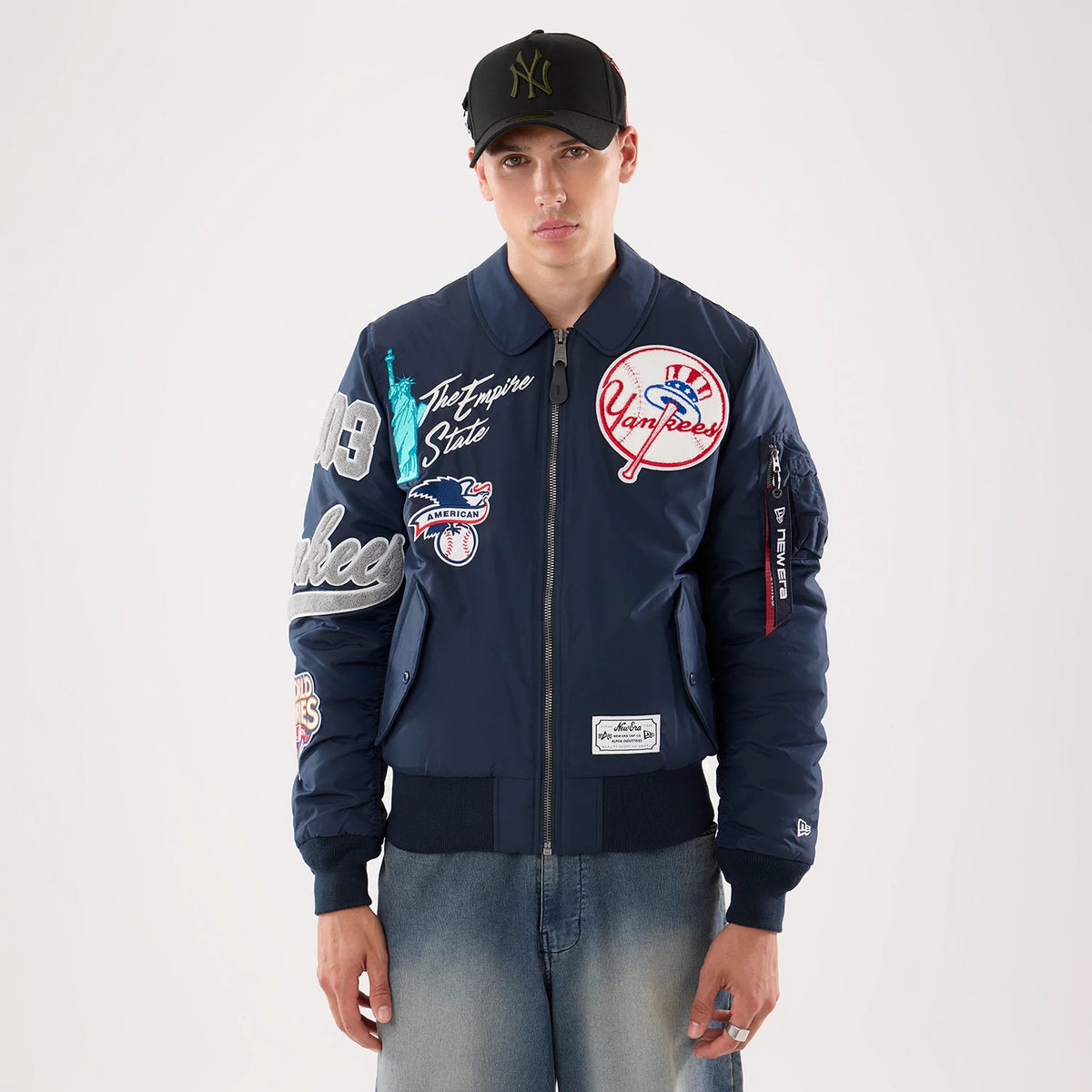 The model is wearing this MLB X Alpha New York Yankees Jacket in navy. 1