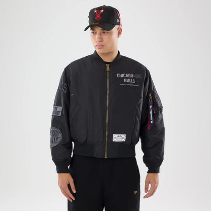 The model is wearing this NBA X Alpha Chicago Bulls Bomber Jacket & Tactical Vest in black. 1