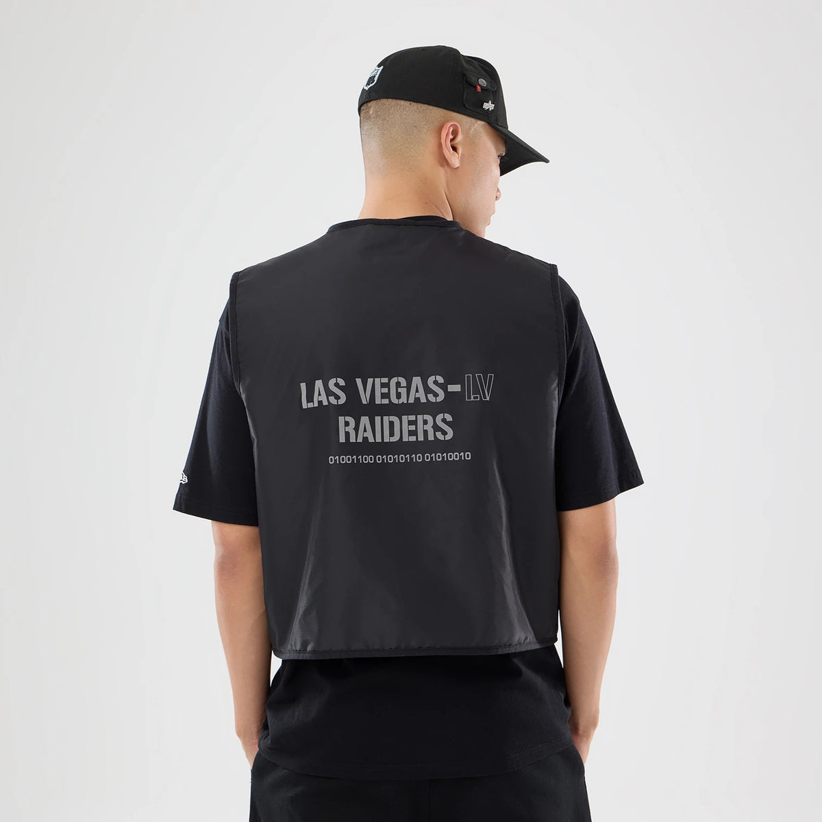 The model is wearing this NFL X Alpha Las Vegas Raiders Bomber Jacket & Tactical Vest in black. 2