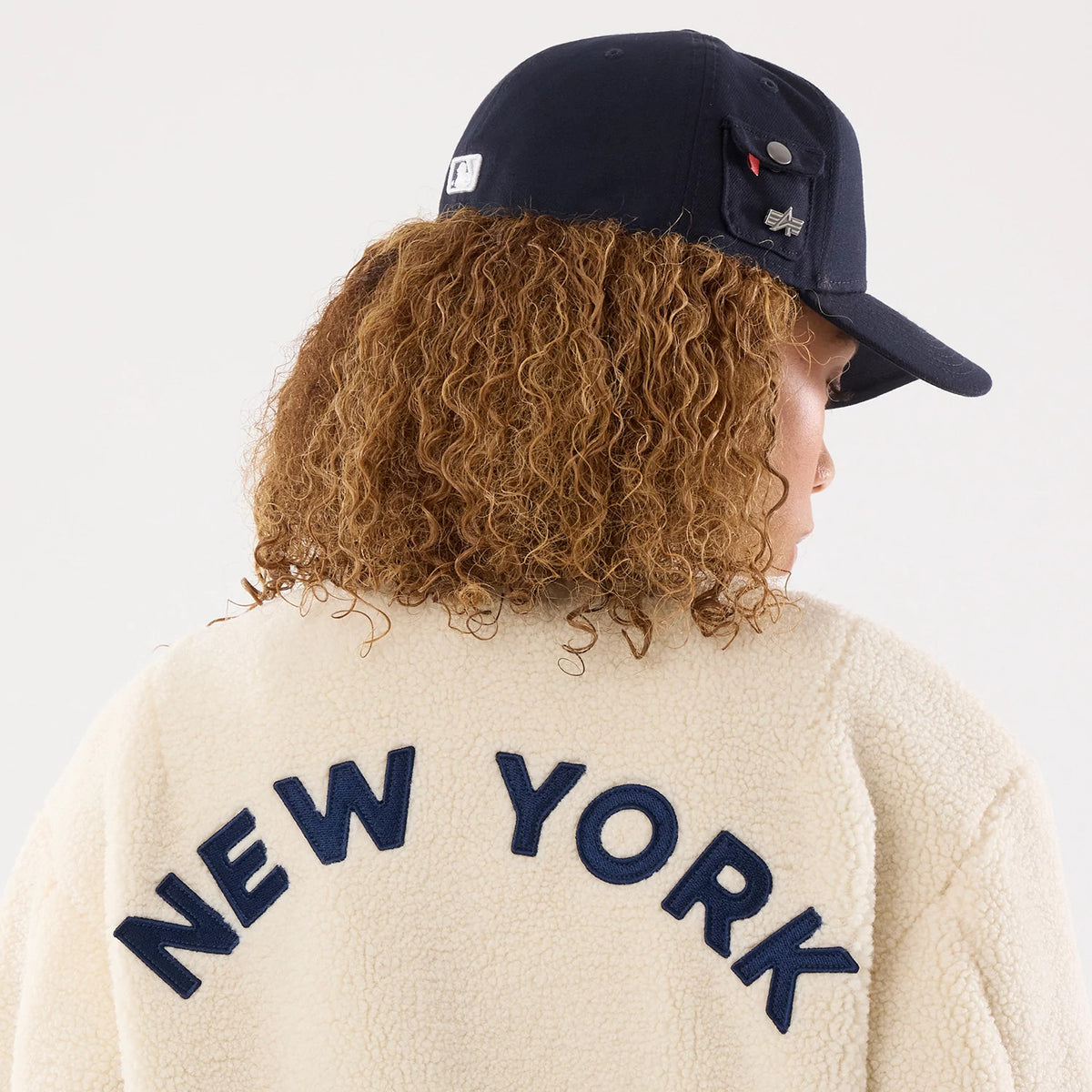 The model is wearing this MLB X Alpha New York Yankees Borg Jacket in cream. 6