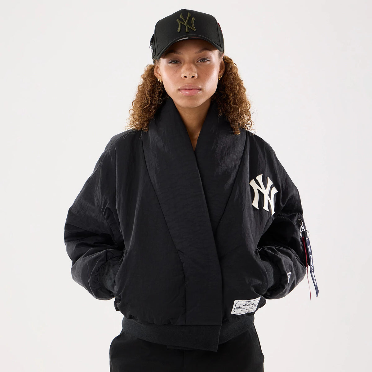 The model is wearing this MLB X Alpha New York Yankees Jacket in black. 1