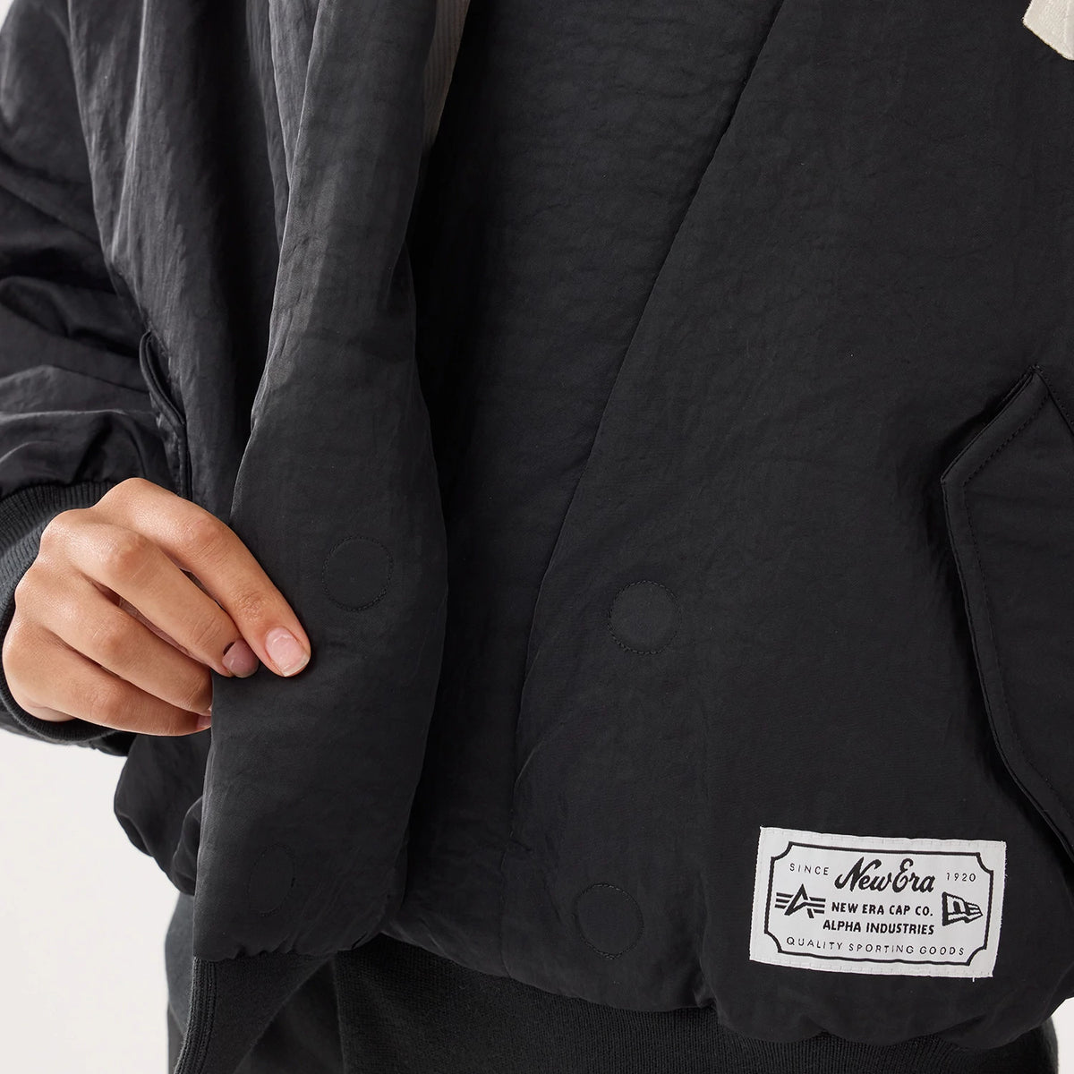The model is wearing this MLB X Alpha New York Yankees Jacket in black. 3