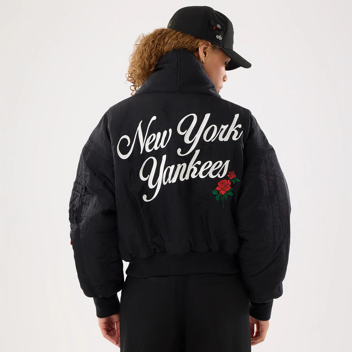 The model is wearing this MLB X Alpha New York Yankees Jacket in black. 2