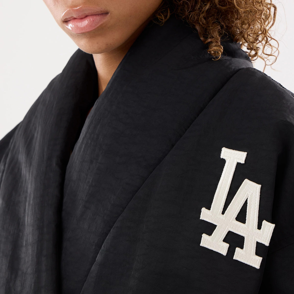 The model is wearing this MLB X Alpha LA Dodgers Jacket in black. 3