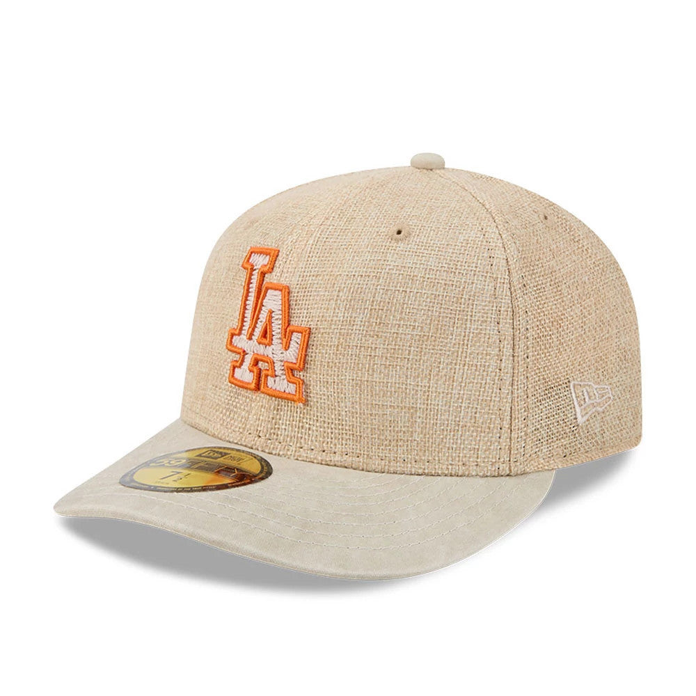 LA Dodgers MLB Halloween Beige New Era 59FIFTY Fitted Cap, three-quarter view showing the orange embroidered LA logo on the front panel, the gold 59FIFTY size sticker on the beige visor, and the New Era flag logo on the left side.