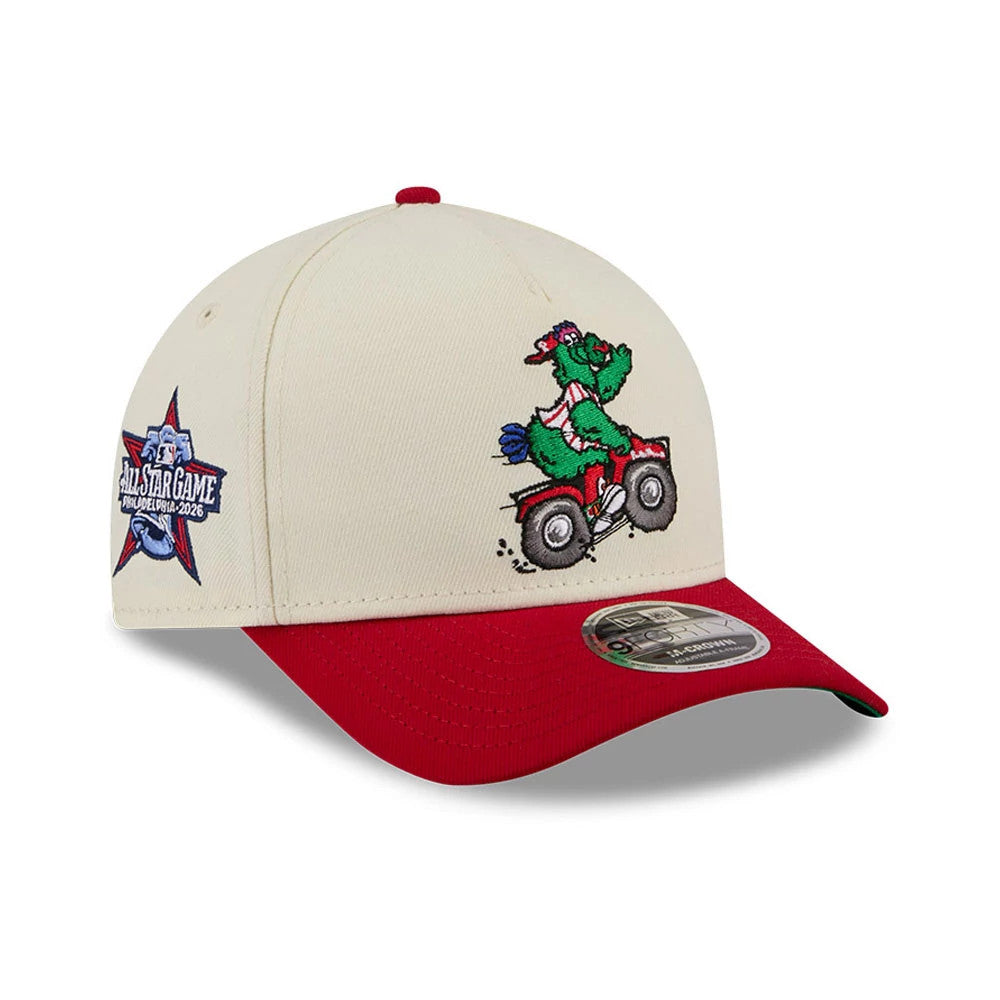 Phillies MLB All Star Game Cream New Era 9FORTY M-Crown A-Frame Adjustable Cap, three-quarter view showing a colourful embroidery of a mascot on a bike on the front panel, a red visor with a 9FORTY size sticker, and an All Star Game logo on the side.