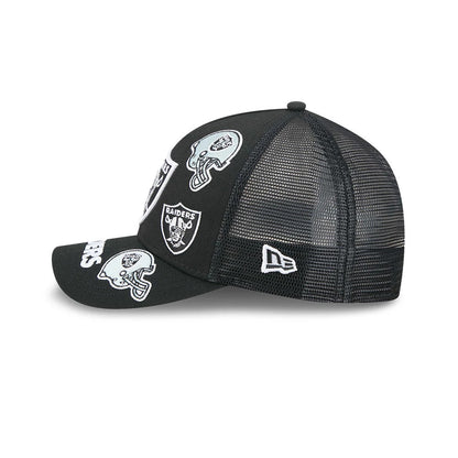 Raiders NFL All Over Black New Era 9FORTY M-Crown A-Frame Trucker Adjustable Cap, side view showing the embroidered Raiders logos on the structured black front panels, with a white New Era flag on the black mesh side panel.
