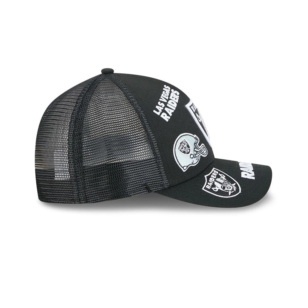 Raiders NFL All Over Black New Era 9FORTY M-Crown A-Frame Trucker Adjustable Cap, side view showing white Las Vegas Raiders text embroidered on the black front panel, with mesh back panels.
