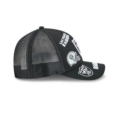 Raiders NFL All Over Black New Era 9FORTY M-Crown A-Frame Trucker Adjustable Cap, side view showing white Las Vegas Raiders text embroidered on the black front panel, with mesh back panels.