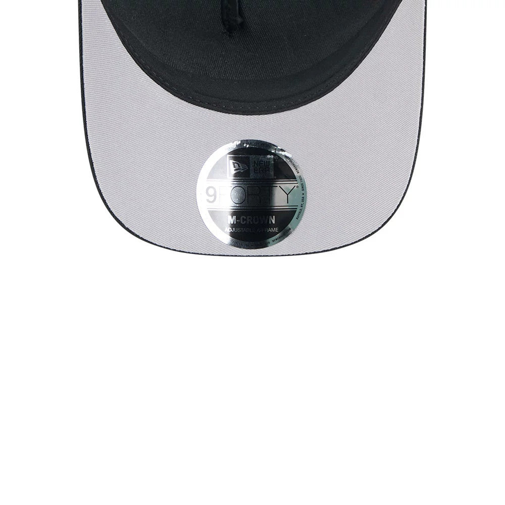 Raiders NFL All Over Black New Era 9FORTY M-Crown A-Frame Trucker Adjustable Cap, close-up showing a black curved visor with a grey undervisor, featuring a reflective 9FORTY size sticker prominently placed at the centre.