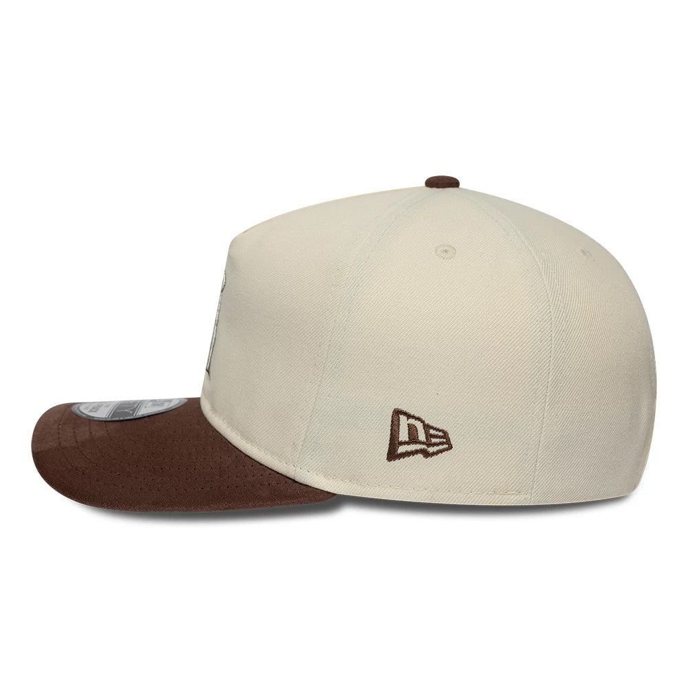 LA Angels MLB Suede Visor Cream New Era 9FIFTY A-Frame Adjustable Cap, side view showing the brown embroidered New Era flag logo on the left side of the cream crown, with a brown suede visor and a 9FIFTY size sticker.