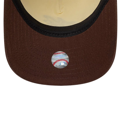 New Era Suede Visor Cream 9FIFTY A-Frame Adjustable Cap, inside view showing a brown suede undervisor with a reflective sticker featuring a red baseball seam design and black taping lining the edge of the cream sweatband.