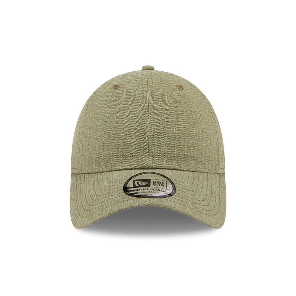 New Era Herringbone Pinstripe Green Casual Classic Adjustable Cap, front view showing a herringbone pattern on the green fabric, a curved visor with a Casual Classic size sticker, and a top button centred above the structured crown.
