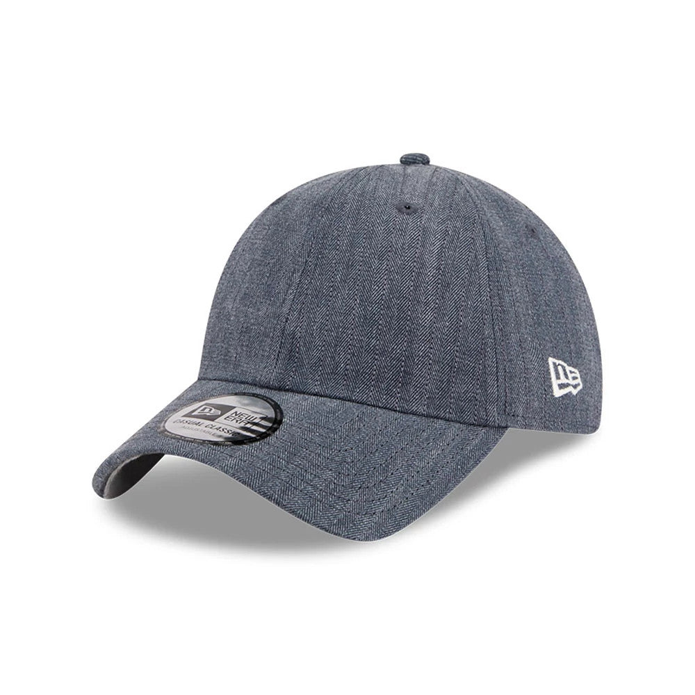 New Era Herringbone Pinstripe Navy Casual Classic Adjustable Cap, three-quarter view showing the white embroidered New Era flag logo on the left side, herringbone pattern across the structured crown.