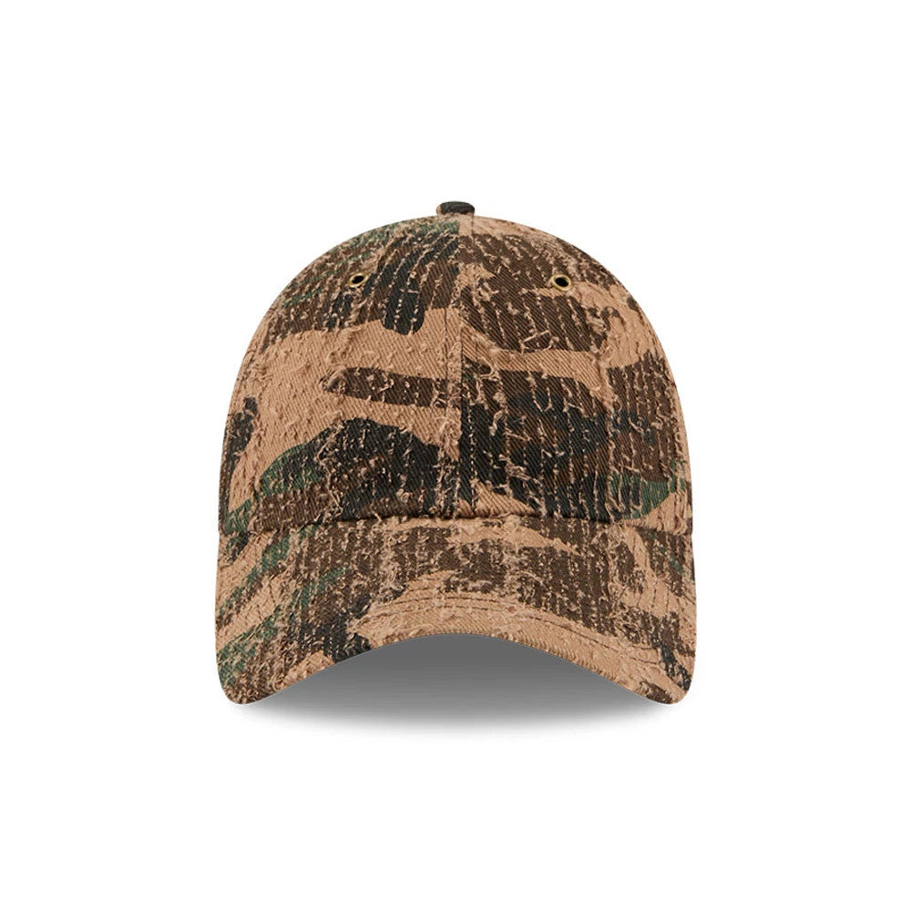New Era Camo Casual Classic Adjustable Cap, front view showing a brown and green camouflage pattern covering the entire structured crown with two embroidered eyelets, paired with a matching curved visor for a cohesive design.