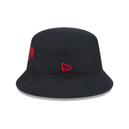 New Era Netflix Stranger Things Black Bucket Hat, three-quarter view showing the red embroidered Stranger Things logo on the side of the black crown, with a red embroidered New Era flag logo beside it and a downward-sloping black visor.