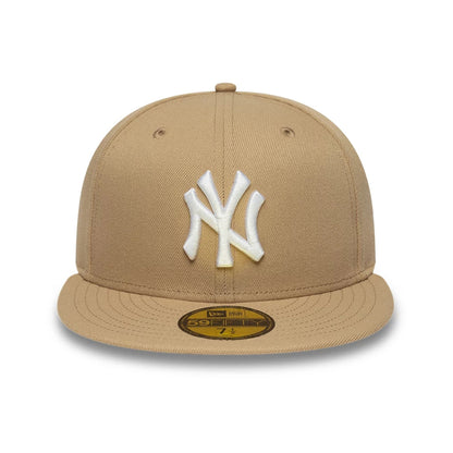 Pictured is this MLB League Essential New York Yankees 59FIFTY Fitted cap in light beige. 2