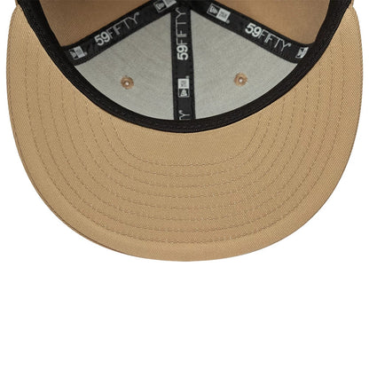 New York Yankees MLB League Essential Light Beige New Era 59FIFTY Fitted Cap, inside view showing the woven black 59FIFTY taping around the interior seams, a grey fabric lining under the crown with matching beige embroidered eyelets.