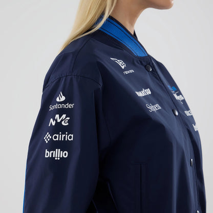 New Era Womens Williams Navy Varsity Jacket, side view showcasing the navy sleeve with branded white printed logos including Santander and airia, a New Era embroidered logo on the chest, and a blue striped ribbed collar with press studs on the front.