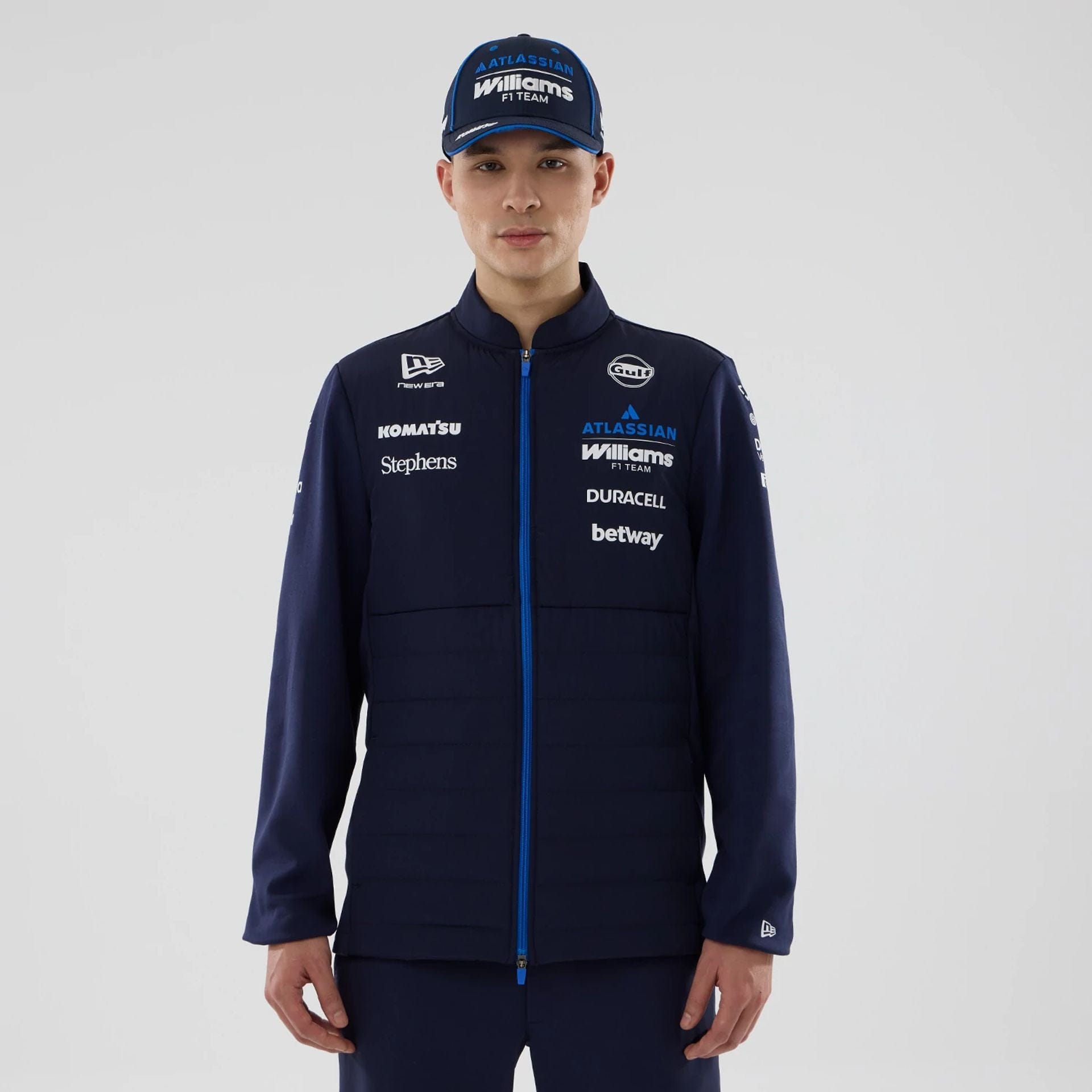 The model is wearing this Atlassian Williams F1 Team Hybrid Jacket in navy. 1