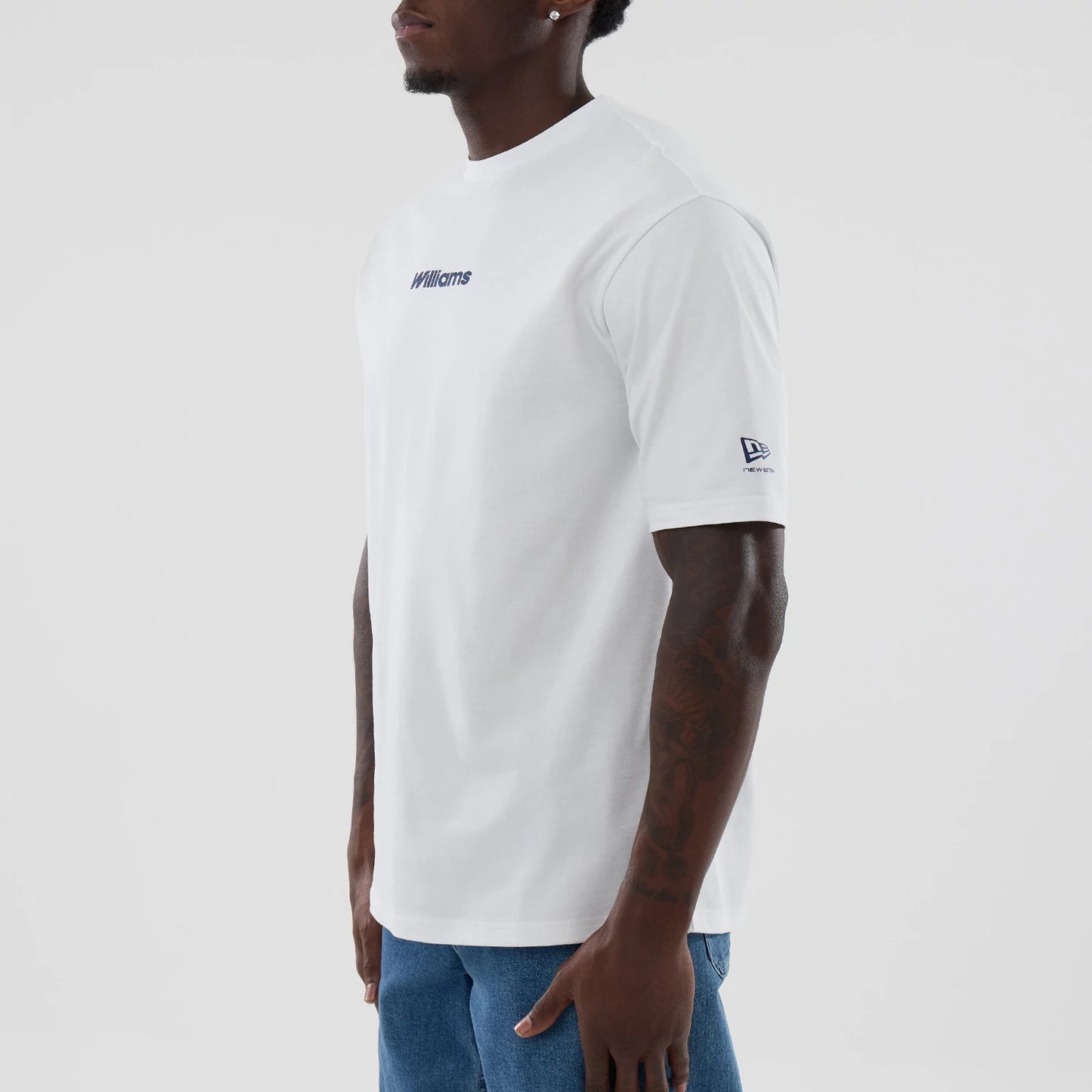 The model is wearing this Atlassian Williams F1 Team Japan 1996 Script World Champions Oversized T-Shirt in white. 3