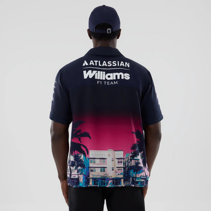 New Era Williams Miami Navy Short Sleeve Shirt, back view on a model with a navy cap, showing white Atlassian and Williams F1 Team lettering across the upper back and a pink and navy Miami cityscape and palm tree graphic on the lower section.