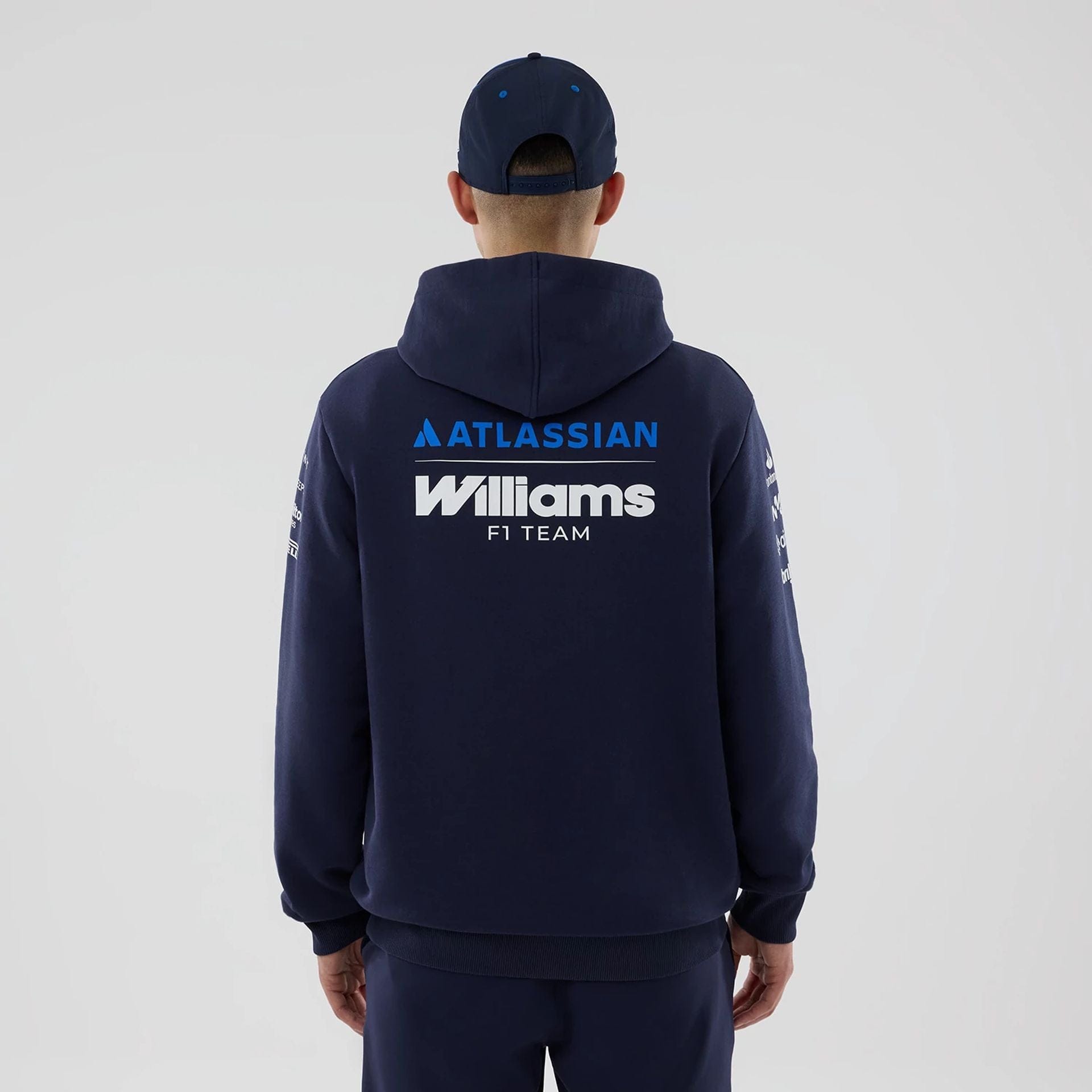 The model is wearing this Replica Atlassian Williams F1 Team Pullover Hoodie in navy. 2