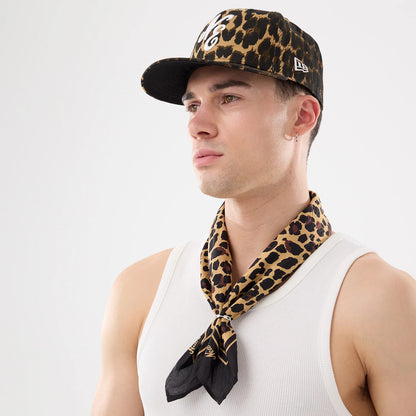 New Era New York Yankees MLB Rib White Vest, on-model view wearing a white ribbed vest with a black and brown leopard print cap featuring a raised white logo on the front panel, styled with a matching leopard print scarf.