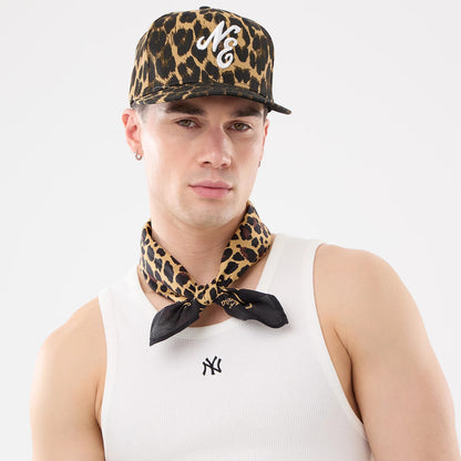New Era New York Yankees MLB Rib White Vest, on-model view with a white ribbed vest featuring a small black Yankees logo on the chest, paired with a leopard print cap with an embroidered NY and a matching leopard print neck scarf.