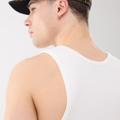 New Era New York Yankees MLB Rib White Vest, rear view on a model wearing a dark patterned cap, highlighting the ribbed texture of the sleeveless back panel and the neckline of the white vest.