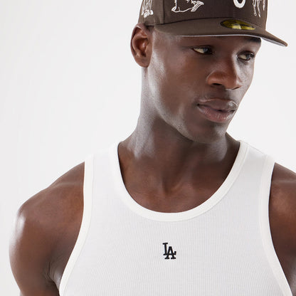 New Era LA Dodgers MLB Rib White Vest, on-model view styled with a brown cap, featuring a black embroidered LA logo on the front of the ribbed white fabric, creating a clean and athletic look.