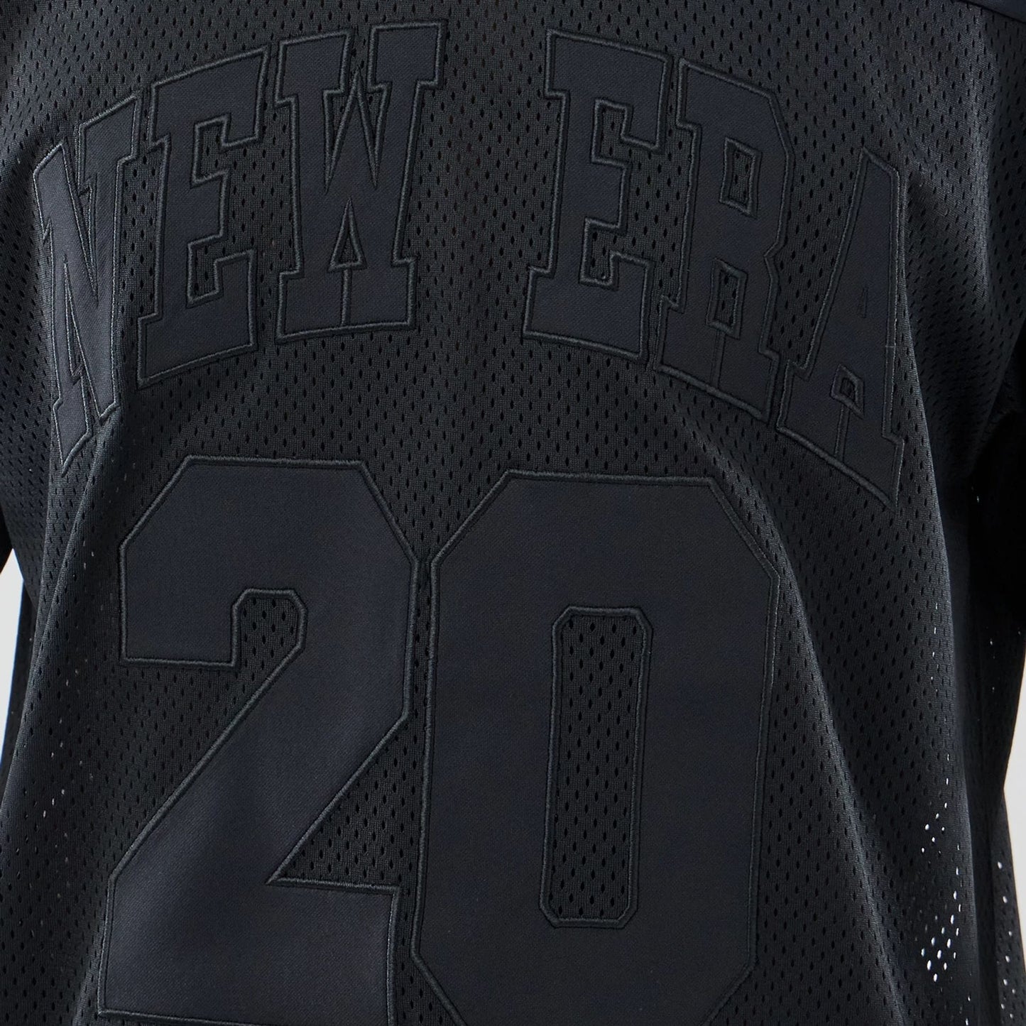 The model is wearing this New Era Mesh Oversized T-Shirt in black. 4