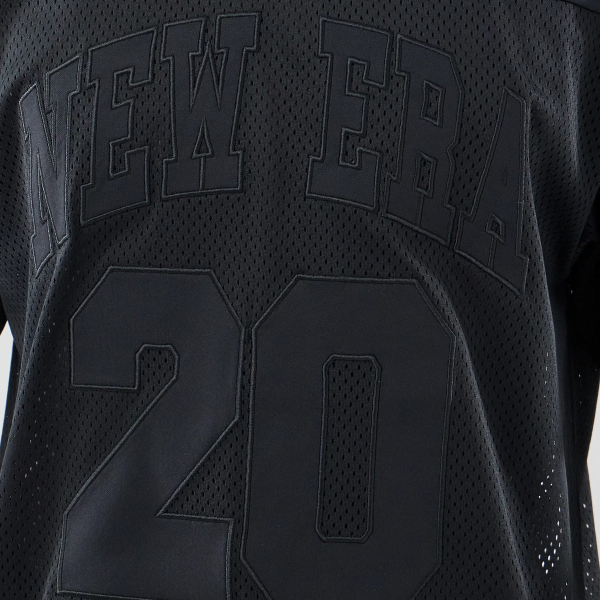 The model is wearing this New Era Mesh Oversized T-Shirt in black. 4